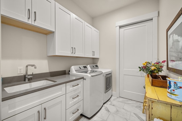 washroom featuring cabinets, washer and clothes dryer, and sink