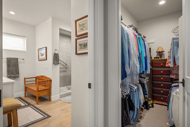 walk in closet with light wood-type flooring