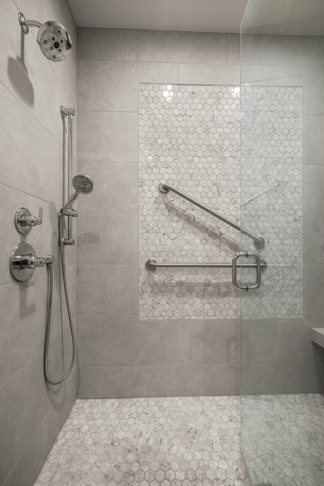 bathroom featuring a shower with shower door