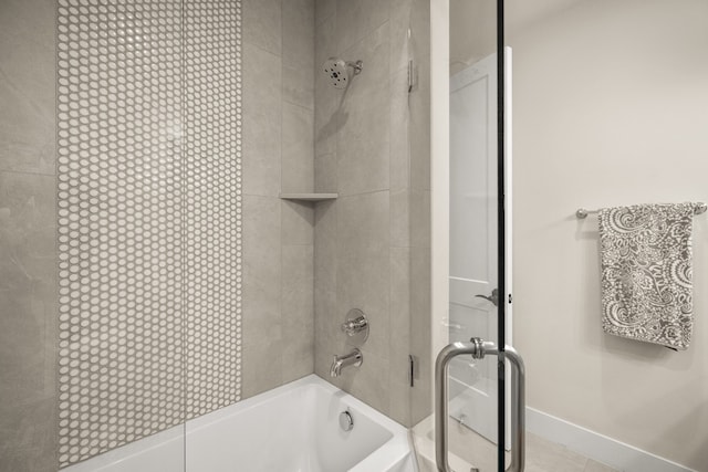 bathroom with tiled shower / bath and tile patterned floors