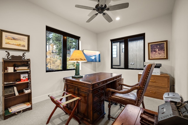 office space with light carpet and ceiling fan