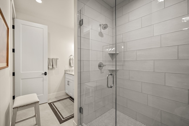 bathroom featuring an enclosed shower, vanity, and tile patterned flooring