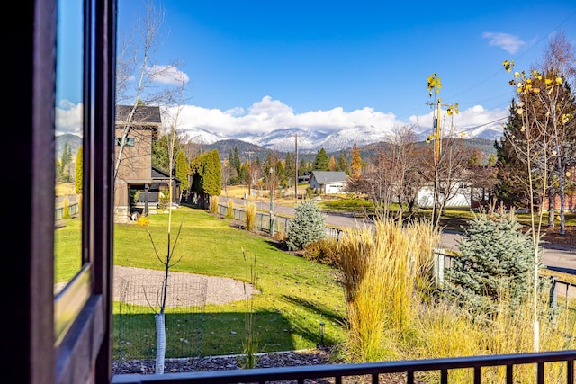 exterior space with a lawn and a mountain view