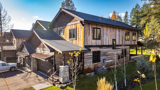 view of side of home featuring a garage and central AC