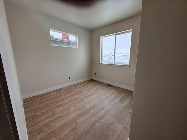 unfurnished room featuring light hardwood / wood-style floors