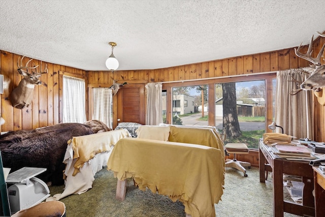1312 2nd Ave E, Kalispell, MT 59901 - bedroom with a textured ceiling, carpet flooring, and wood walls