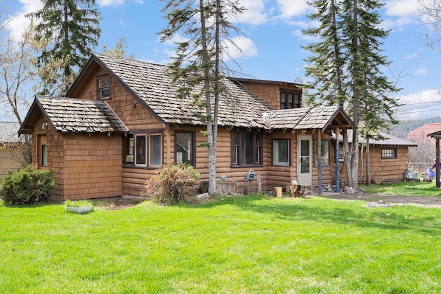 rear view of property with a lawn