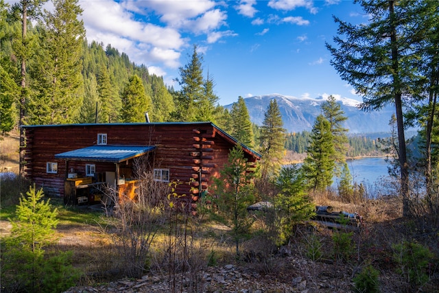 view of side of home with a water and mountain view