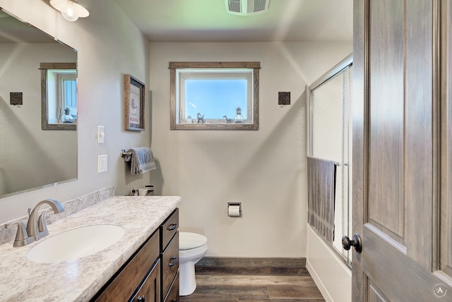 bathroom with hardwood / wood-style floors, vanity, and toilet