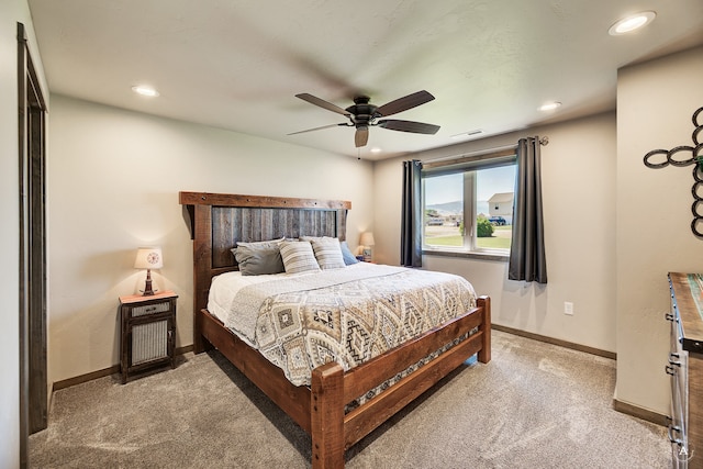 bedroom featuring light carpet and ceiling fan