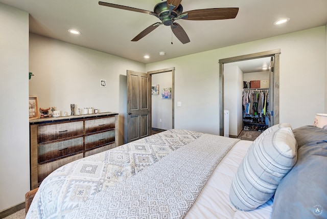 bedroom featuring a spacious closet, ceiling fan, and a closet