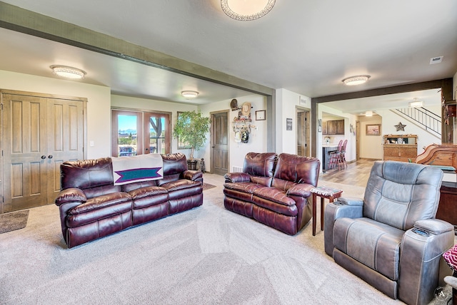 living room featuring light carpet and french doors