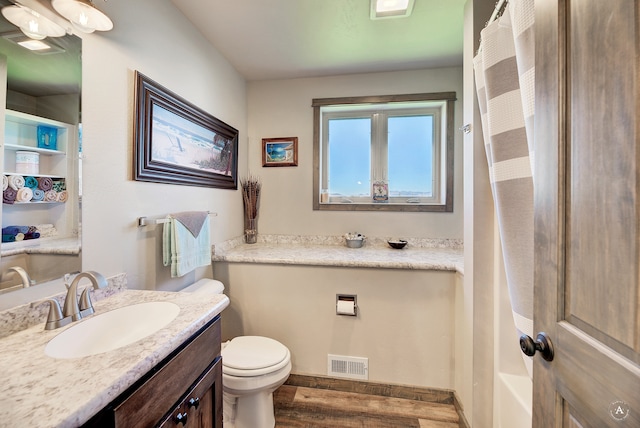 full bathroom with toilet, shower / tub combo with curtain, vanity, and hardwood / wood-style flooring