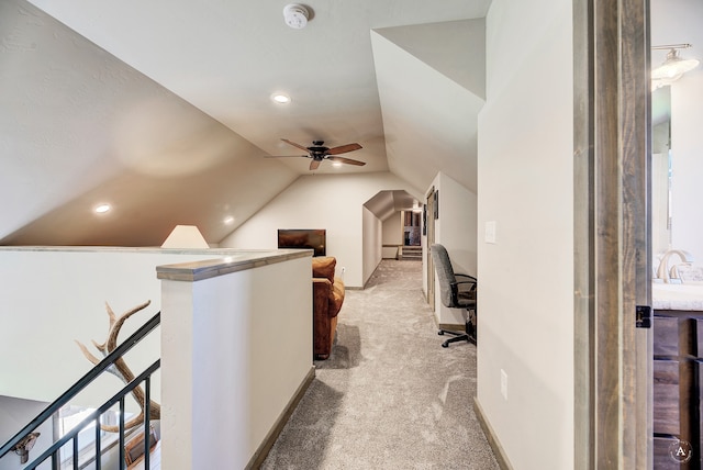 carpeted home office featuring ceiling fan and vaulted ceiling