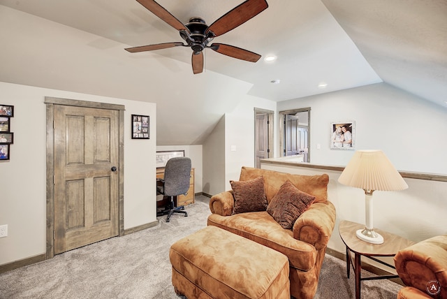 carpeted living room with ceiling fan and vaulted ceiling