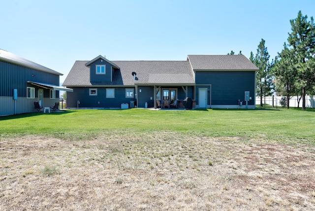 back of house with a lawn