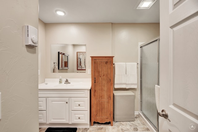 bathroom featuring walk in shower and vanity