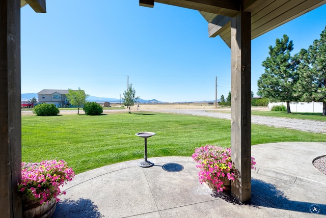 view of yard featuring a mountain view and a patio