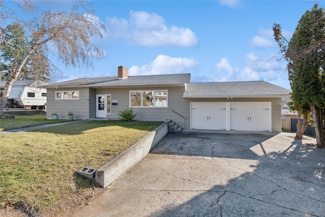 ranch-style house with a garage and a front lawn