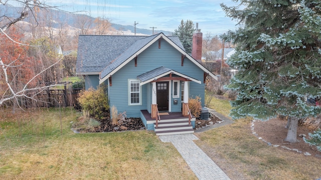 bungalow-style home featuring a front yard