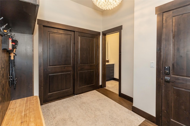 3868 Gelande St Unit 4, Whitefish, MT 59937 - entryway featuring baseboards, a notable chandelier, and dark wood-type flooring