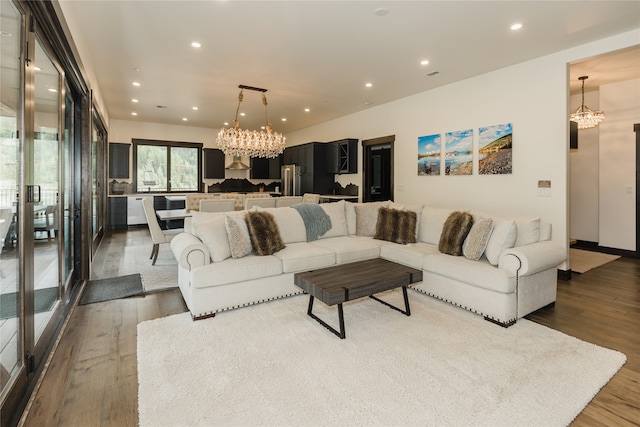 living room featuring dark hardwood / wood-style flooring and an inviting chandelier