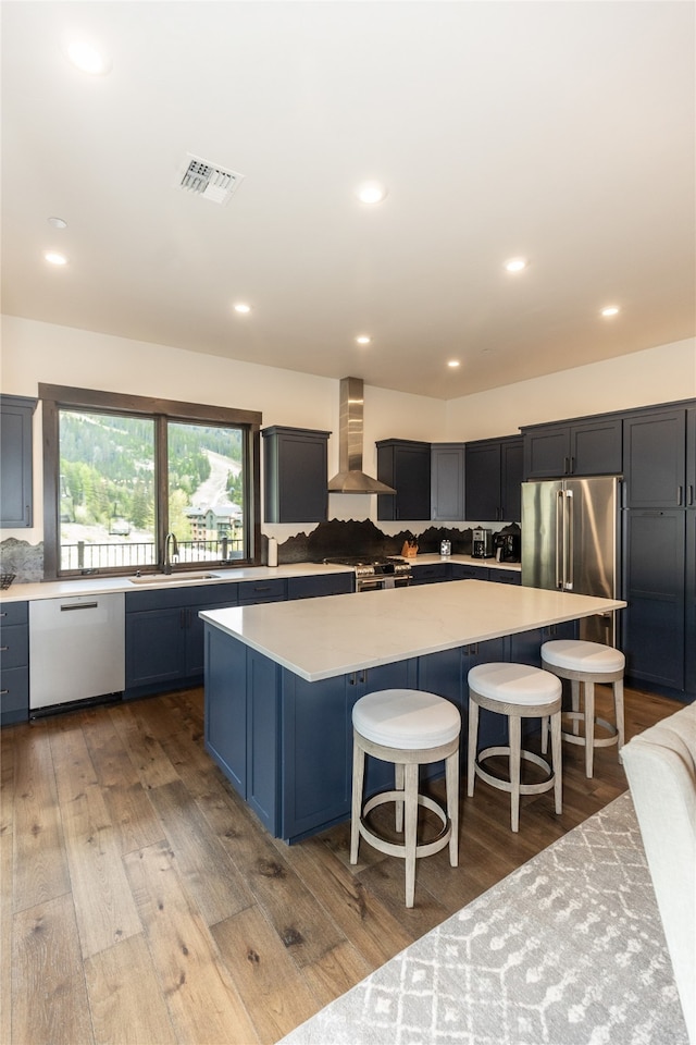 3868 Gelande St Unit 4, Whitefish, MT 59937 - kitchen with visible vents, dishwasher, tasteful backsplash, a sink, and wall chimney range hood