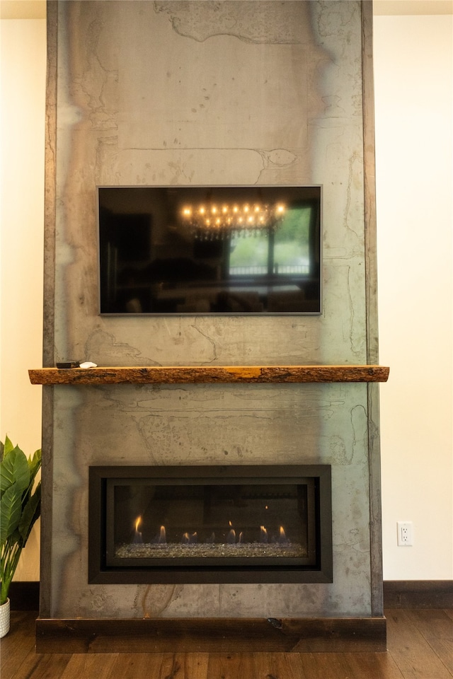 3868 Gelande St Unit 4, Whitefish, MT 59937 - details with baseboards, wood finished floors, and a glass covered fireplace