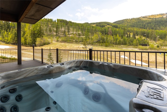 3868 Gelande St Unit 4, Whitefish, MT 59937 - deck with a wooded view and a hot tub