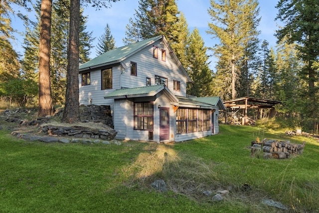 rear view of property with a lawn