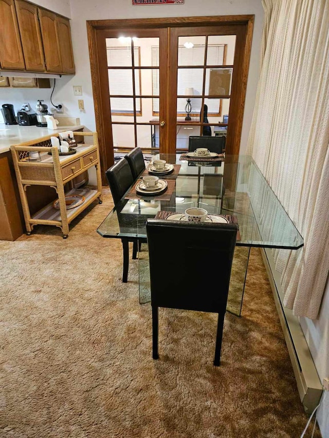 dining room featuring french doors and light colored carpet