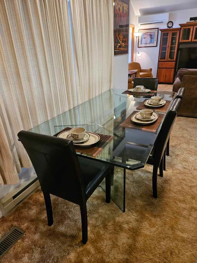 carpeted dining area with a wall mounted AC and baseboard heating