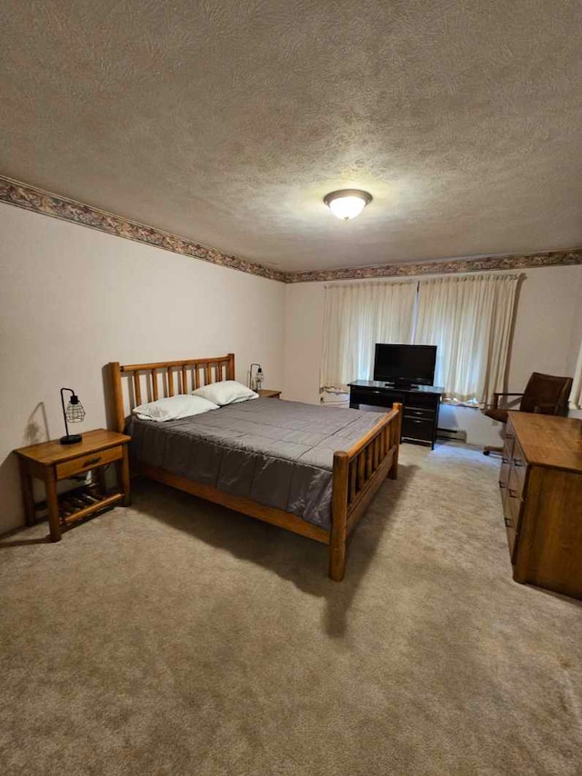 bedroom with a textured ceiling and light carpet