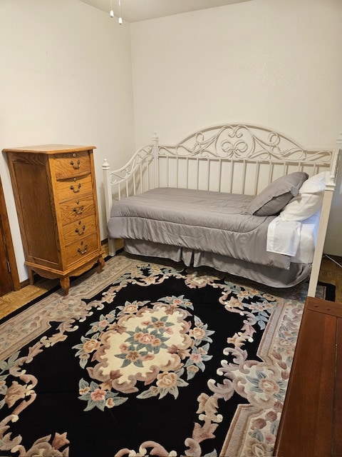 bedroom with wood-type flooring