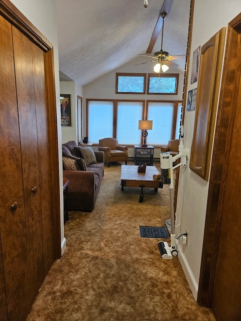 living room with lofted ceiling, ceiling fan, and dark carpet