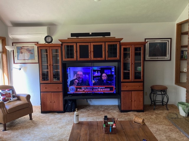 carpeted living room featuring a wall unit AC