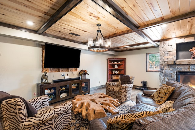 16485 Folsom Rd, Florence, MT 59833 - living room with baseboards, wooden ceiling, beamed ceiling, a chandelier, and a stone fireplace