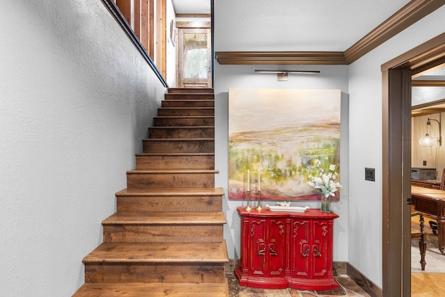 16485 Folsom Rd, Florence, MT 59833 - stairway with crown molding, plenty of natural light, a textured wall, and baseboards