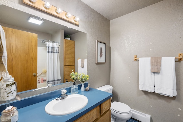 16485 Folsom Rd, Florence, MT 59833 - full bathroom featuring baseboard heating, a textured wall, a shower with curtain, toilet, and vanity