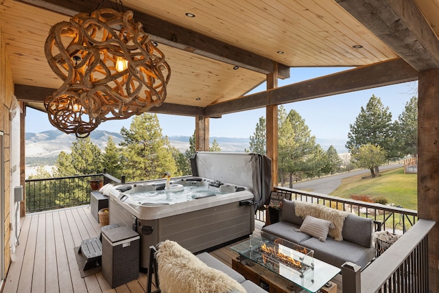 16485 Folsom Rd, Florence, MT 59833 - wooden terrace featuring a hot tub, a mountain view, and an outdoor living space with a fire pit