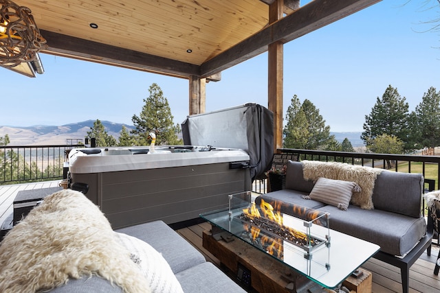 16485 Folsom Rd, Florence, MT 59833 - wooden deck with a mountain view, an outdoor living space with a fire pit, and a hot tub