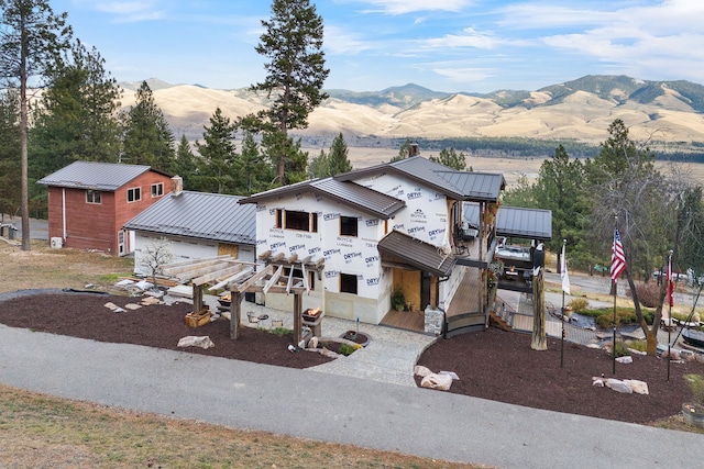 16485 Folsom Rd, Florence, MT 59833 - view of front facade with a mountain view, metal roof, and a standing seam roof