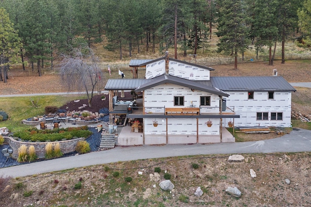 16485 Folsom Rd, Florence, MT 59833 - view of front facade featuring metal roof, fence, stairway, and a standing seam roof