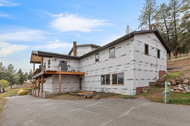 16485 Folsom Rd, Florence, MT 59833 - back of house featuring a balcony and a chimney