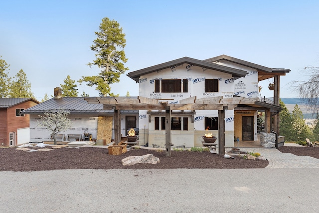 16485 Folsom Rd, Florence, MT 59833 - view of front of house with a chimney, metal roof, and a standing seam roof