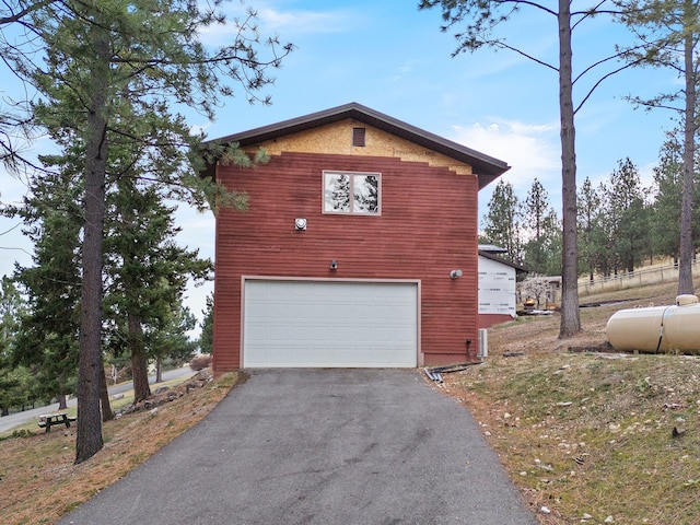 16485 Folsom Rd, Florence, MT 59833 - view of property exterior with asphalt driveway and a garage