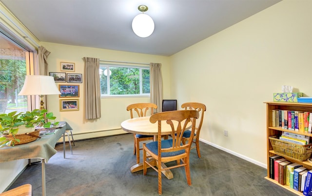 carpeted dining area featuring a baseboard radiator