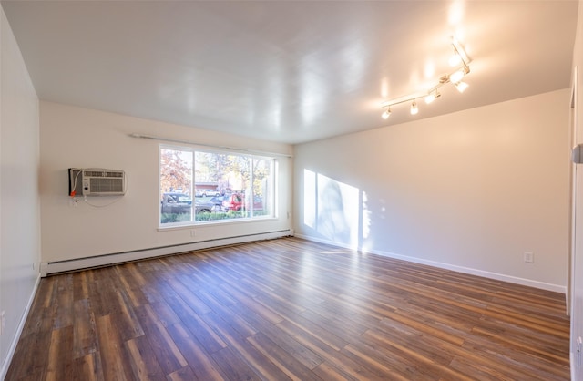 unfurnished room featuring dark wood-type flooring, a wall unit AC, and a baseboard radiator