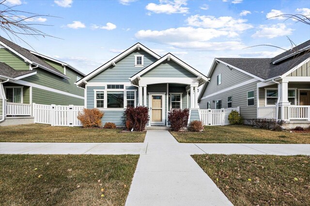 view of front of property with a front yard and covered porch