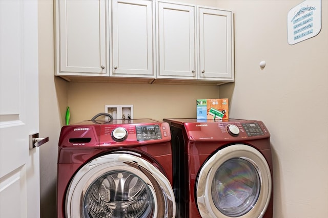 laundry room with cabinets and washer and dryer